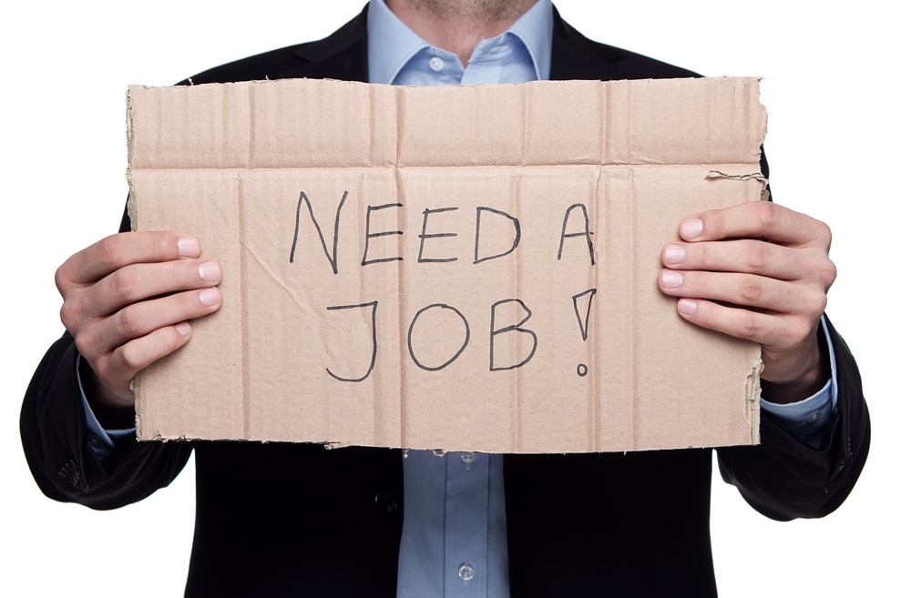 Man holding need a job sign