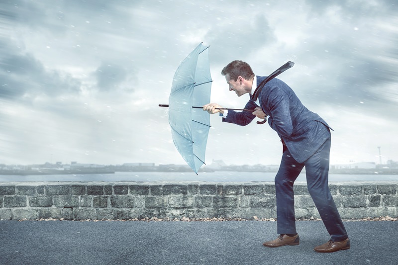 Man with umbrella facing into the wind