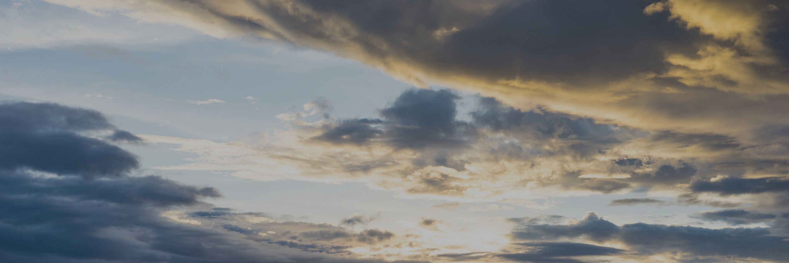 A picture of a cloudy landscape lit from the bottom by sunshine