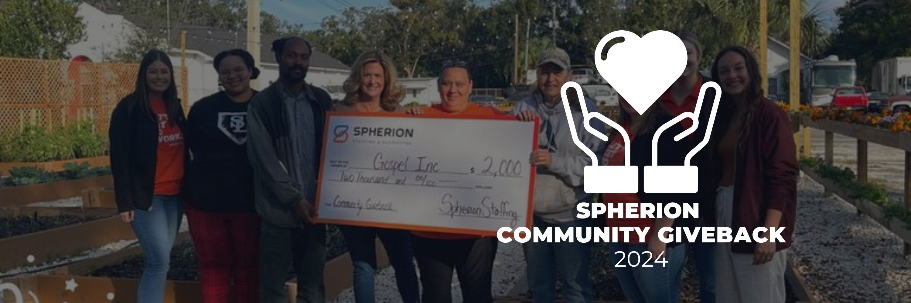 A group of people holding a big check for $500 for a nonprofit