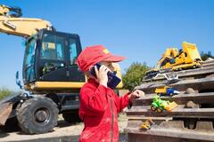 Boy with construction toys on site